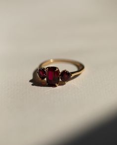 Red Ruby Diamond Ring, Three Stone Gemstone Ring, Elongated Cushion & Round Cut Engagement Ring, Past Present Future Wedding Ring, 14K Gold Item Description: Stone - Simulant Diamond Stone Shape - Elongated Cushion & Round Cut 1. White Gold: 10K/14K/18K 2. Yellow Gold: 10K/14K/18K 3. Rose Gold: 10K/14K/18K 4. Silver: Sterling Silver 925 Size Customization: What Size you want... * You can also Customize ring size in US 4 to US 12! It sometimes affects to price. * Main Stone & Shape Customization: Antique Ring Round Stone, Square Ruby Engagement Rings, Engagement Ring With Small Ruby, Gold Gemstone Ring Set, Elegant Luxury Ruby Ring Gift, Luxury Heirloom Garnet Rings, Antique Ruby Ring Stone, Raw Ruby Engagement Rings, Luxury Dainty Ruby Engagement Ring