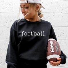 Experience ultimate comfort and style with our Football Sweatshirt. Made with soft and cozy material, this sweatshirt is perfect for any casual occasion. Embrace its simplicity and elevate your wardrobe. Get yours now and feel the passion of the game! Specifications: Brand: Gildan Neckline: Crew Neck Fit: Unisex Color: black/white Material: 50% cotton 50% polyester Sizing recommendation: For a more fitted look, it is recommended to size down one size. Stay with your true size for a relaxed fit. Black Sweatshirt For Game Day In Fall, Casual Black Sweatshirt For Football Season, Black Team Spirit Sweatshirt For Fall, Black College Sweatshirt For Football Season, Black Long Sleeve Sweatshirt For Game Day, Black Football Season Sweatshirt, Fall Team Spirit Sweatshirt With Ribbed Cuffs, Trendy Game Day Crew Neck Sweatshirt, Game Day Long Sleeve Sweatshirt For Football Season