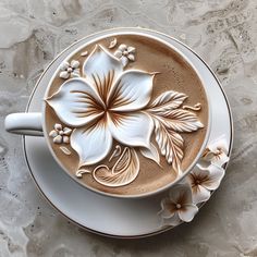 a cappuccino with white flowers on it