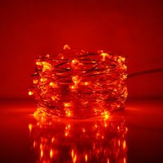 an orange string of lights on a dark surface