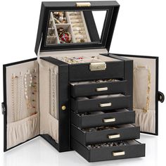 an open black jewelry box with several drawers and necklaces in it on a white surface