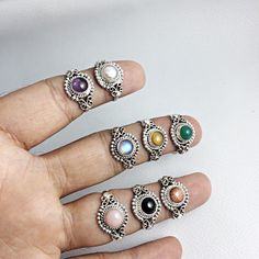 Solid 92.5% Sterling Silver Handmade Ring With Semi Precious Cabochons Gemstones Gemstone - Gemstone Size - 6 mm Ring Size :- A - 6.5 US ( Amethyst ), B - 6 US ( Pearl ), C - 9 US ( Pink Opal ), D - 8 US ( Sun Stone ), E - 8 US ( Green Onyx ), F - 7.25 US ( Black Onyx ), G - 9 US ( Rainbow Moonstone ), H - 9 US ( Tigereye ) QTY - 1 piece in this listing. We are manufacturer of silver jewellery , silver findings and gemstones . We manufacture all the at our factory with our skilled workers that l Metal Jewelry With Natural Stones In Round Shape, Round Metal Jewelry With Natural Stones, Silver Jewelry With Natural Stones, Silver Jewelry With Natural Round Stones, Silver Jewelry With Round Gemstone, Adjustable Opal Ring With Natural Stones, Adjustable Cabochon Round Stone Jewelry, Adjustable Round Crystal Ring With Stone Setting, Natural Silver Moonstone Gemstones