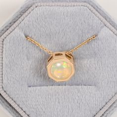 Looking for the perfect engagement gift? The Ethiopian Opal Pendant, with its minimalist style, is the perfect engagement pendant. made of 14/18k solid gold, statement jewelry for women. octagon-shaped natural opal pendant ideal for brides-to-be. an anniversary gift or a cherished present for a beloved daughter  Ethiopian Opal Pendant, 14/18k Solid Gold, Floating Pendant, Unique Round Opal Necklace, Wedding Gift for Bride, Minimalist Necklace for Her ★ ★ CUSTOM/DUTY-FREE SHIPPING WORLDWIDE, BUYE Minimalist Jewelry With Tension Setting For Anniversary, Minimalist Anniversary Jewelry With Tension Setting, Modern Necklace With Round Cut For Gift, White 14k Gold Solitaire Necklace For Gift, White Solitaire Pendant Necklace In 14k Gold, Modern 14k Gold Round Pendant Jewelry, White 14k Gold Solitaire Pendant Necklace, Anniversary Yellow Gold Necklaces With Tension Setting, Modern Solitaire Diamond Cut Necklace For Gift