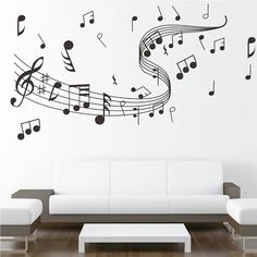 a living room with white furniture and musical notes on the wall