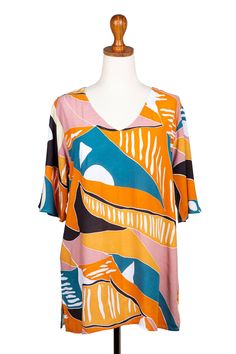 Breezy and comfortable, this cheerful rayon tunic will add a welcome splash of color to your wardrobe. Hari and Arthur in Bali design the top, which features a rounded V-neckline and three-quarter length sleeves. Casual Multicolor V-neck Tunic, Multicolor Half Sleeve Tops For Beach, Printed Half Sleeve Tops For Vacation, Summer Multicolor Split Neck Tops, Vibrant Print V-neck Tunic, Multicolor Split Neck Summer Top, Multicolor Split Neck Top For Summer, Summer V-neck Rayon Blouse, Flowy Split Neck Summer Tops