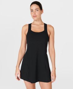 Our sporty new workout dress for styling out the sweatiest of sessions. Sweat-wicking Power Pro fabric is breathable and stretchy with a matte finish. Slim, body-skimming fit with contrasting panels and a flattering racerback. Supportive inner shorts with slip pocket. In-built bra with removable pads. Length: 77.5cm / 31". Model wears size S and is 178cm/5'10" tall. Style Code: SB9287BColour: Black Black Tennis Dress With Built-in Bra, Sporty Tennis Dress With Built-in Bra For Gym, Athleisure Tennis Dress For Workout, Workout Dresses With Built-in Bra And Racerback, Sporty Fitted Moisture-wicking Dress, Sporty Sleeveless Dress With Built-in Bra, Sporty Black Stretch Tennis Dress, Sporty Sleeveless Black Tennis Dress, Solid Sleeveless Yoga Dress