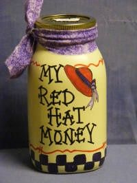 a jar that has some kind of decoration on it with a purple ribbon around the top