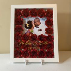 a wedding photo frame with red roses in it