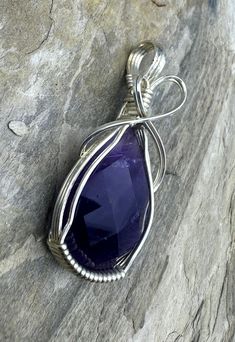 Heidi White Designs Wire Wrapped Pendant Amethyst and Sterling Silver1&1/2 X 3/4 inchThis is a ready to wear or use in one of your own designs wire wrapped pendant. This pendant is wrapped in sterling silver wire and features a natural faceted Amethyst Cabochon. Faceted Gemstone Jewelry, Wire Wrap Pendant, Small Pendant, Wrapped Pendant, Turquoise Pendant, Wire Wrapped Pendant, Turquoise Beads, White Design, Beaded Pendant