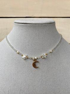 this gorgeous celestial necklace is perfect for anyone who loves the moon. White Moon Phase Celestial Necklace, White Celestial Moon Phase Necklace, White Celestial Necklace With Moon Phase, White Celestial Necklace With Moon Charm, Celestial Style Beaded Necklaces As Gift, Celestial Style Round Beaded Necklaces Gift, Handmade White Celestial Necklace, Celestial Style Beaded Necklaces With Round Beads For Gifts, Bohemian White Moon Necklace