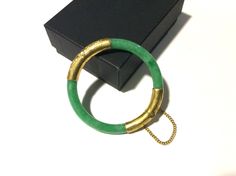 "FREE SHIPPING! Beautiful Vintage 1960's to 1970's (received as wedding gift and could be from the 40's or '50's or older, as they get passed down through family).  Apple green jade bangle 22k to 24k yellow gold wrapping, filigree engravings and safety chain.  This fits smaller wrist measuring 2 1/8\" or 53mm.  The width of the jade bangle is 9/32\" or 7.14mm. My belief is this apple green jade bangle is real jade and untreated due to age with normal inclusions and line fractures.  If this was color enhanced, it would definitely not last in color as there was no real technology.  The last picture shows the Chinese characters normally for this style.  This workmanship is rare. This is in very good condition considering wear and age.  When bracelet is open, there is a minor play at the hinge Vintage Bangle Bracelets For Wedding, Vintage Bangle Jewelry For Wedding, Vintage Bangle For Wedding, Vintage Hinged Bracelets For Wedding, Vintage Round Cuff Bracelet For Formal Occasions, Vintage Hinged Bangle As Gift, Vintage Cuff Bracelet For Formal Occasions, Vintage Hinged Bangle Gift, Retro Jubilee Bracelet Jewelry As Gift