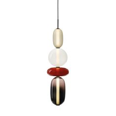 three different colored glass pendants hanging from a ceiling fixture on a white background,