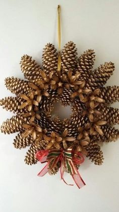 a pine cone wreath hanging on the wall