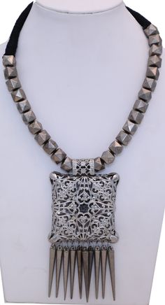 Vintage style modern boho silver necklace with a carved hollow oxidized silver pendant that has small silver conical drops falling down to give a fancy look.  The look is very dressy rustic tribal with oxidized silver rings running throughout the black rope neckline. #tlb #Handmade #BohoFestivalJewelry #CarvedPendantNecklace #OxidizedSilverNecklace Unique Silver Metal Beaded Necklaces, Silver Beaded Pendant Necklace, Bohemian Silver Jewelry With Dangling Beads, Silver Necklaces With Dangling Beads For Festivals, Bohemian Antique Silver Jewelry With Silver Beads, Unique Silver Beaded Metal Necklace, Silver Necklace With Dangling Beads For Festivals, Antique Silver Beaded Bohemian Jewelry, Unique Silver Beaded Necklaces For Festival