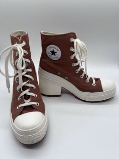 Elevate your casual style with these limited edition Converse Chuck 70 De Lux Heel Hi Pride sneakers. The tawny owl color with glitter accents adds a touch of uniqueness to any outfit. These high top sneakers have a lace-up closure for a secure fit and a rubber outsole for durability. The synthetic upper material is breathable and comfortable, while the foam insole provides added support. Perfect for walking, these athletic sneakers are suitable for all seasons. With a style code of A05253C and a US shoe size of 10 (women's 8), these Converse Chuck 70 sneakers are a must-have for any sneaker enthusiast. Shoes For Women Sneakers & Athletic, Converse High Heels, Pride Sneakers, Converse Heels, Real Outfits, Heel Sneakers, Therian Stuff, Tawny Owl, Hot Clothes