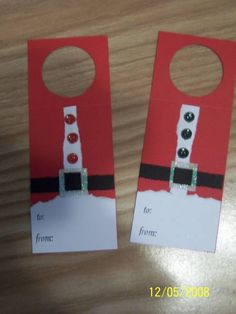 two door hangers made to look like santa's house with buttons on them