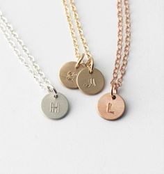 "Our tiny initial necklace is dainty and meaningful. This classic necklace is great for everyday wear or layering. Choose your number of discs and metal to wear your favorite initials close to your heart. D E T A I L S -Choose from 1-3 tiny discs -Disc measures 8mm -Choose 14kt Gold-Filled, Sterling Silver, or Rose Gold-Filled. -A high quality delicate link chain with a spring clasp. -Polished to a light satin finish. CUSTOM HAND STAMPING -Hand stamped with an initial. -This disc can also be lef Minimalist Rose Gold Hand Stamped Charm Necklaces, Everyday Rose Gold Initial Necklace With Adjustable Chain, Minimalist Hand Stamped Rose Gold Charm Necklace, Minimalist Rose Gold Hand Stamped Charm Necklace, Dainty Adjustable Rose Gold Charm Necklace, Simple Rose Gold Charm Necklace For Everyday, Minimalist Nickel-free Initial Pendant Charm Necklace, Rose Gold Initial Necklace With Delicate Chain, Dainty Rose Gold Initial Necklace With Charms