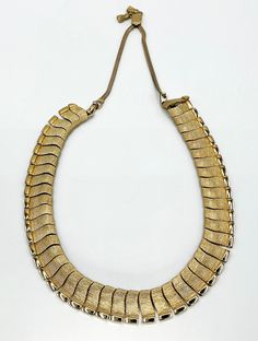 Vintage Monet Segmented Goldtoned Panels Snake Chain Necklace. The necklace hangs down 9". It is in excellent condition. The little sements are .25"x .75". Retro Adjustable Gold Necklace, Adjustable Retro Gold Necklace, Vintage Adjustable 16 Inch Necklaces, Vintage Adjustable 16-inch Necklaces, Vintage Gold-tone Chain Necklace With Lobster Clasp, Vintage Gold-tone Necklace With Adjustable Chain, Retro Gold Necklace With Adjustable Chain, Vintage Adjustable Chain Necklace, Vintage Gold Necklace With Box Chain