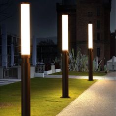 three lights that are standing in the grass