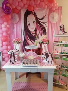 a table topped with lots of pink and white balloons next to a wall covered in pictures