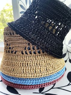 The raffia crochet bucket hat is the epitome of a versatile summer accessory. With its lightweight and breathable design, it effortlessly transitions from a chic sun hat for lounging by the beach to a practical straw gardening hat for tending to your plants with style. Its intricate crochet pattern adds a touch of bohemian charm, making it a fashionable choice for any summer outing. Either you're strolling through the farmer's market or enjoying a picnic in the park, this knit bucket hat provides both sun protection and a laid-back, slouchy vibe, ensuring you stay cool and stylish all season long. Color: multiple One size Materials: raffia Processing time: Up to 5 business days Delivery time: 7-14 business days Personalization: I can create a product according to your wishes, in the desire Spring Straw Bucket Hat, Woven Summer Bucket Hat, Wide Brim Cotton Yarn Crochet Hat For Vacation, Vacation Crochet Hat With Short Brim, Woven Bucket Hats For Summer, Curved Brim Crochet Cotton Hat For Vacation, Curved Brim Crochet Hat In Cotton Yarn For Vacation, Vacation Bucket Hat With Woven Detail, Spring Bucket Straw Hat