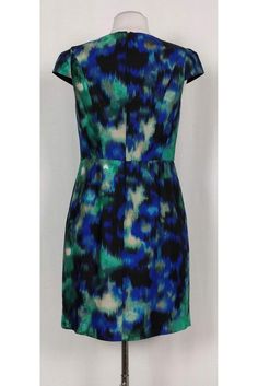 Stunning dress in a bold green, black and blue print. Made with a rounded neckline, cap sleeves and a fitted waist. This chic garment can be styled with stilettos and a solid colored clutch for a dinner date look that will wow. Size 4 Silk & cotton blend Rounded neckline Short cap sleeves Concealed back zipper Lined Pleated skirt Above knee Pockets Bust 33" Waist 28" Shoulder to hem 35" Chic Blue Dress With Abstract Print, Fitted Green Dress With Abstract Print, Green Fitted Dress With Abstract Print, Elegant Blue Dress With Abstract Print, Fitted Green Cap Sleeve Dress, Blue Fitted Dress With Abstract Print, Blue Short Sleeve Dresses With Abstract Print, Blue Short Sleeve Dress With Abstract Print, Blue Abstract Print Short Sleeve Dress