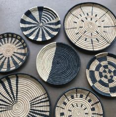 four black and white baskets sitting on top of a table