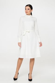 "A collared midi dress featuring a button front closure (imitation), fabric belt, and a fit and flare silhouette. - fit and flare silhouette - high rounded collar - knee length (midi) - long sleeves with cuffs - fabric belt - covered button front decor - concealed zipper closure - lined bodice and skirt - color: white Fiber: 60% viscose, 35% polyester, 5 % elastane, Lining - 95 % viscose, 5% elastane. For size S:dress length- 40,0 \" (102 cm), sleeve length 24,21\" (61,5 cm) Our model wears size Elegant Long Sleeve Midi Dress With Belted Cuffs, Chic Long Sleeve Belted Knee-length Dress, Chic Belted Long Sleeve Knee-length Dress, Elegant Long Sleeve Belted Shirt Dress, Fitted Long Sleeve Dresses With Belted Cuffs, Elegant Long Sleeve Belted Midi Dress, Belted Long Sleeve Dress For Spring Formal, Long Sleeve Dresses With Belted Cuffs, Spring Formal Belted Long Sleeve Dress