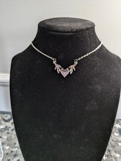 Angels are real, just like you! Embrace the Y2K vibe with this Angel Heart Necklace! This silver chain choker features a delicate heart pendant that is perfect for layering or as a statement piece on its own! Add a touch of heaven to your look ✨😇 Sizing is intended to be a loose choker style, but is adjustable by 3-4 inches! Small customizations (such as length) can be done easily as all pieces are made by me! Just send me a message and I'll do my best to accommodate your request! Y2k Style Clavicle Chain Necklace, Valentine's Day Choker Chain Necklace, Metal Heart Charm Choker Necklace, Heart Charm Y2k Jewelry For Gifts, Silver Heart Choker Necklace With Chain, Gothic Clavicle Chain Necklace With Heart Pendant, Y2k Style Heart Charm Jewelry Gift, Silver Gothic Heart Charm Necklace, Silver Metal Heart Choker Necklace