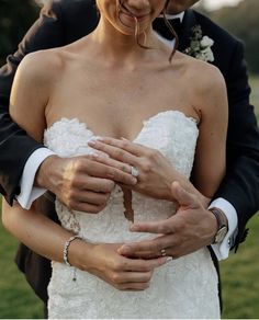 a bride and groom holding each other in their arms