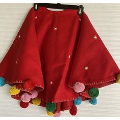 a red skirt with pom poms hanging from it