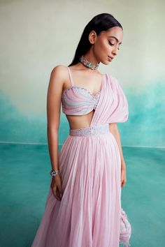 Introducing "bloomsy" - where elegance meets comfort! Our orchid pink bloomsy skirt saree is a one-of-a-kind creation, featuring a hand-embroidered bustier blouse adorned with mesmerizing double buttonhole stitches and shiny cutdanas. What sets this ensemble apart is its innovative design, allowing the dupatta to seamlessly attach to the skirt, granting you the look of a saree without the hassle of draping. Double Button Hole Stitch, Skirt With Blouse, Bustier Blouse, Skirt Saree, Button Hole Stitch, Embroidered Bustier, Pink Pleated Skirt, Draped Skirt, Button Hole