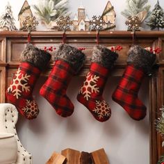 christmas stockings hanging from a mantle with snowflakes