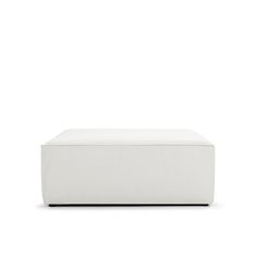 a white ottoman sitting on top of a white floor