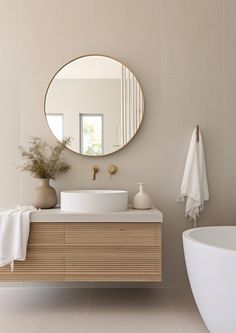 a bathroom with a sink, mirror and bathtub