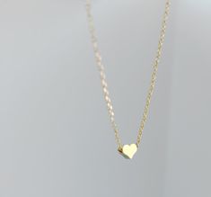 "Dainty necklace, gold Heart necklace, gold necklace, Dainty jewelry, gift for her, simple necklace, gift for women, dainty necklace, birthday gift for her Simple and dainty gold heart necklace. D E T A I L S: *5mm tiny gold plated heart *18\" gold plated chain *Lobster clasp closure This style is also available in rose gold and silver in our shop! SHIPPING: *Free domestic shipping on all orders PACKAGING: *All pieces come beautifully packaged, perfect for gift giving. Find more to ❤️ here: http Simple Necklace With Heart Charm As A Gift, Simple Gold Charm Necklace For Valentine's Day, Tiny Dainty Heart Necklace For Gift, Dainty Tiny Heart Necklace For Gifts, Dainty Small Heart Necklace For Gift, Dainty Gold Plated Necklace For Valentine's Day, Tiny Dainty Heart Necklace Gift, Simple Heart Pendant Charm Necklace For Gift, Simple Heart Pendant Charm Necklace As Gift