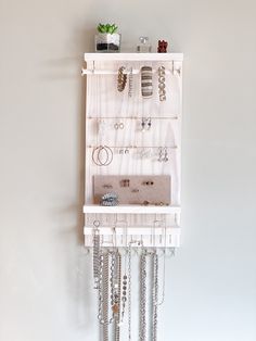 a jewelry organizer hanging on the wall