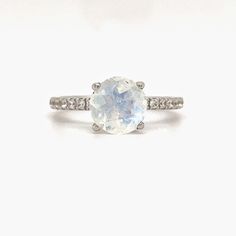 M A T E R I A L S ~ Solid Sterling Silver ~ Gold Vermeil & Rose Gold Vermeil (Heavy Plating over Sterling Silver) S T O N E S Cruelty Free ~ Genuine Moonstone ~Flawless/Colorless Simulated Diamond ~ Center Stone : 2.00ct ~ 1/2 Eternity Band Stones: 0.16ct TOTAL: 2.25 ctw D I M E N S I O N S ~ Band: 1.75mm ~ Setting: 8.0mm Height 7.5mm Width R I N G C A R E ~ Simple instructions to care for the ring is not expose your jewelry to chemicals like bleach, chlorine, hairspray, to avoid chemical re Celestial White Moonstone Birthstone Ring, Celestial White Moonstone Ring As Birthstone, Celestial Style White Moonstone Birthstone Ring, White Moon-shaped Birthstone Rings, White Moon Shaped Ring With Birthstone, White Birthstone Ring In Moon Shape, White Celestial Opal Ring, White Oval Moonstone Ring With Center Stone, White Moon-shaped Opal Gemstone Ring