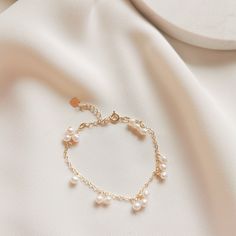 DAINTY BRACELET | DELICATE PEARL BRACELET | DAINTY ANKLET | FRESHWATER PEARL BRACELET | 14K GOLD FILLED PEARL BRACELET | STERLING SILVER PEARL BRACELET | WHITE PEARL GOLD BRACELET | BRIDAL BRACELET | GOLD BRACELET |  Julie Small Pearl Bracelet 🤍 S T Y L E 🤍 * small freshwater pearls with 14k gold-filled or 925 sterling silver chain bracelet. * The matching necklace version here👉: https://www.etsy.com/au/listing/1454534234 * The matching earrings version here👉:  🤍 M E A S U R E M E N T S 🤍 * Length Bracelet: total approx. 15cm + 5cm extender * Pearl size approx. 3-4mm  🤍 M A T E R I A L S 🤍 * Pearl Freshwater Pearl * Metal Yellow Gold: 14k gold-filled  Silver: 925 Sterling Silver 🤍 P E R S O N A L I S E D 🤍 If you wish to have your jewelry made with other shapes or numbers of pear Wedding Pearl Bracelet With Metal Charm, Adjustable Gold Pearl Bracelet With Pearl Charm, Adjustable Gold Bracelet With Pearl Charm, Pearl Bracelet With Pearl Drop, Pearl Crystal Bracelet With Pearl Charm As Gift, Elegant Beaded Metal Bracelets With Pearl Charm, Elegant Dangle Pearl Charm Bracelets, Adjustable Gold Pearl Chain Bracelet, Pearl Drop Bracelet Jewelry