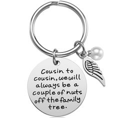 a metal keychain with an angel wing and quote on the front that says, cousin