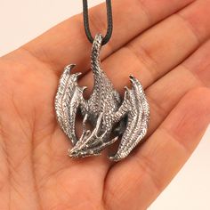 Silver Dragon Necklace, Iron Dragon Pendant This is a Stylish Sterling Silver Dragon Necklace. It is unique by its shape and unusual appearance which will give you inexplicable charm. Dimensions: 48 x 34 mm You will receive one ring identical to those in the photo. Weight with the chain: 15 gr Material: 925 sterling silver All my jewelry is shipped in gift packaging. Gift messages can be inserted into the package. Please always stay one step ahead of the tarnish and take care of your silver jewe Handmade Alloy Jewelry As Gift, Handmade Alloy Jewelry For Gifts, Hand Cast Metal Amulet Necklaces, Silver Charm Necklace In Alloy, Symbolic Silver Alloy Jewelry, Hand Cast Metal Necklace With Round Pendant, Hand Cast Metal Pendant Jewelry, Hand Cast Metal Round Pendant Necklace, Hand-cast Metal Pendant Jewelry