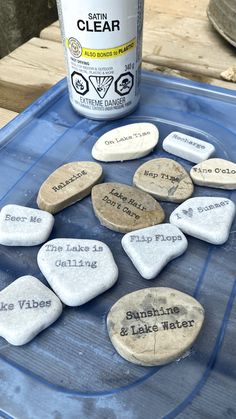 some rocks that have been placed on top of a table with paint and glue next to them