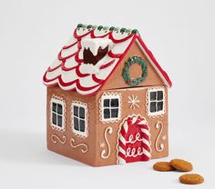 a gingerbread house and cookies on a white background