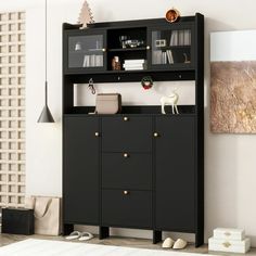 a black bookcase with shelves and drawers in the corner next to a white rug