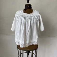 Hello and welcome to the Textile Trunk! Please follow us on Instagram , our user name is textiletrunk A fabulous rare find! Lace trimmed, GORGEOUS! his textile is a choir blouse dating from c 1900 or late 1800's. Made of crispy white cotton , This shirt was a Choir blouse and has lovely mends! ~ it was used and loved. There are some small stains on the back of one of the sleeves near the mends that would probably come out with some spot bleach work! I LOVE this blouse!! ( Eshirt 11094) MEASUREME Victorian Lace Trim Top For Daywear, Cotton Broderie Anglaise Blouse For Daywear, Cotton Blouse With Broderie Anglaise For Daywear, Classic Lace Tops For Daywear, White Cotton Blouse For Gatherings, Broderie Anglaise Cotton Lace Tops For Daywear, Cotton Peasant Blouse For Daywear, Cotton Lace Trim Top For Daywear, Cotton Lace Top With Lace Trim For Daywear