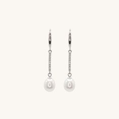 Elevate your style with these stunning sterling silver dangling pearl earrings. These versatile earrings are suitable for any occasion, making them an essential addition to your jewelry collection. For a complete look, pair them with our classic pearl bracelet or necklace collection. Elegant Silver Earrings With Pearl Chain, Elegant Pearl Dangle Earrings, Hypoallergenic Long Drop Pearl Earrings, Classic Sterling Silver Pearl Drop Earrings, Classic Sterling Silver Drop Pearl Earrings, Elegant Long Drop Pearl Pendant Earrings, White Drop Pearl Earrings For Everyday Elegance, Sterling Silver Pearl Chain Earrings For Anniversary, Classic Drop Earrings With Pearl Chain