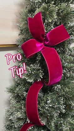 a christmas tree with a red bow on it and the words pro tip written below