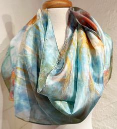 Hand dyed silk scarf in sea blue and coral red colors. 14"x72" premium quality 100% silk.  Each scarf is hand dyed by me in my studio located in Santa Fe, New Mexico.  The process I use makes each scarf uniquely multi-colored, abstract and of singular design. Each item is gift boxed and shipped in waterproof packaging to insure your scarf arrives securely. I make every effort to mail my orders within 2 days of receipt. Care Instructions:  Hand wash in cold water.  Hang to dry and iron if necessary. No bleach. Hand Dyed Silk Scarf, Habotai Silk, Hand Dyed Silk, Coral Blue, Silk Dyeing, Artisan Craft, Santa Fe, Blue Sea, Cold Water