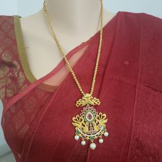 "Handmade Indian Temple Jewelry, best to wear it for traditional ceremonies or Indian wedding. This bridal jewelry has ethnic finish. It has Cubic Zircon stones with ruby and emeralds. It is a Bollywood style one gram jewelry. There are long and short patterns of Indian jewelry in Kundan, Pearls, CZ, American Diamond , ruby, emerald, Polki, kemp to suit every occasion of South Indian and North Indian weddings. Handmade Indian Jewelry item * Stunning Hand made matt finish traditional jewelry set. Temple Jewelry Bridal Necklace With Peacock Design For Rituals, Traditional Long Temple Necklace With Intricate Design, Wedding Temple Necklace With Intricate Design, Wedding Long Temple Necklace With Intricate Design, Bollywood Style Ruby Temple Necklace With Intricate Design, Wedding Kundan Necklace Pendant With Peacock Design, Wedding Kundan Pendant Necklace With Peacock Design, Wedding Kundan Peacock Pendant Necklace, Red Pendant Temple Necklace For Wedding