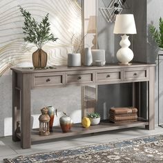 a console table with vases and candles on it in front of a large mirror